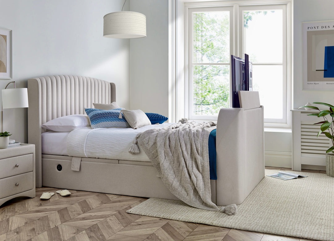 Essence Ottoman Storage TV Bed with USB Charging in Natural Cream Fabric.