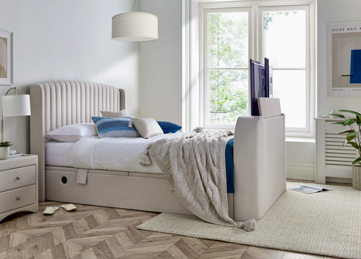 Essence Ottoman Storage TV Bed with USB Charging in Natural Cream Fabric.