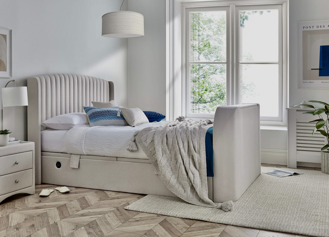 Essence Ottoman Storage TV Bed with USB Charging in Natural Cream Fabric.