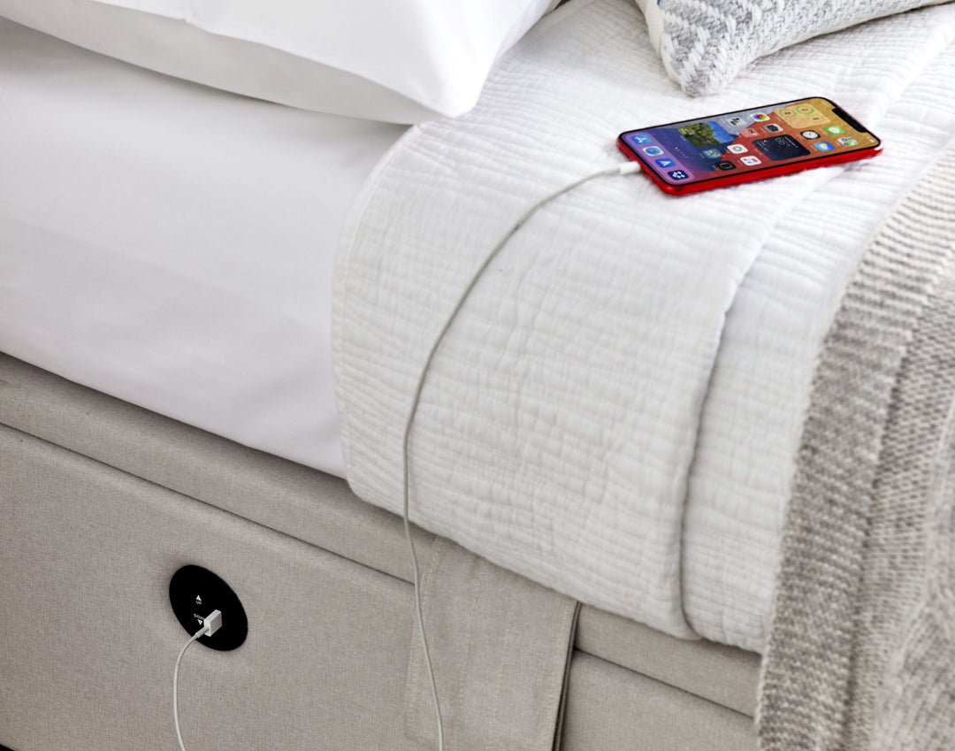 Essence Ottoman Storage TV Bed with USB Charging in Natural Cream Fabric.