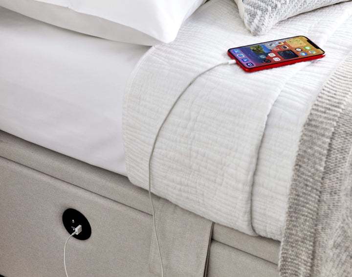 Essence Ottoman Storage TV Bed with USB Charging in Natural Cream Fabric.